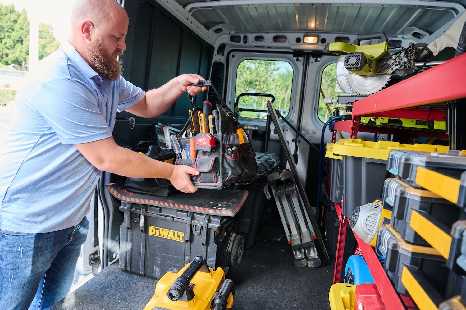 man loading tools into truck